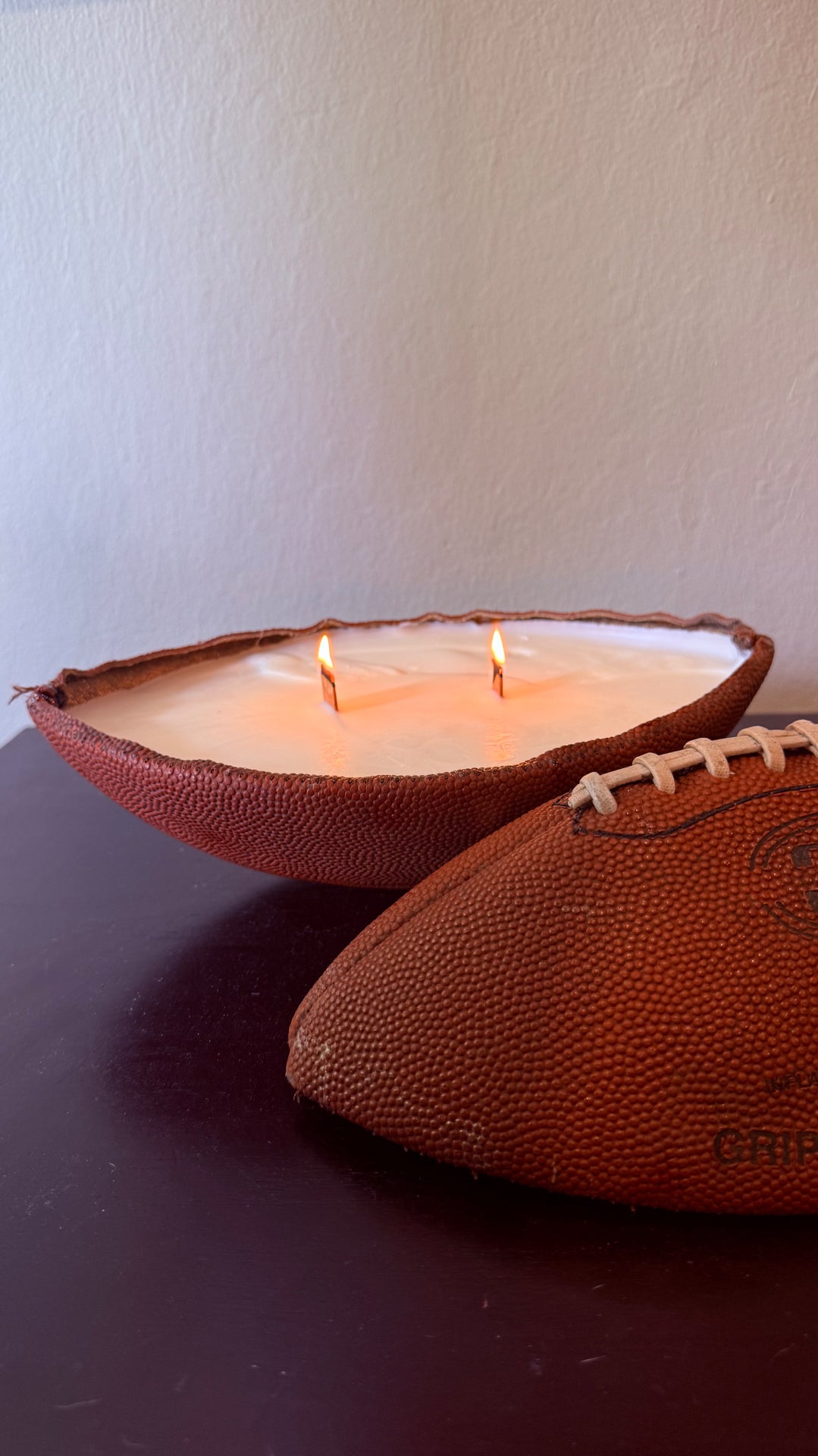 Vintage football candle lit with two wooden wicks