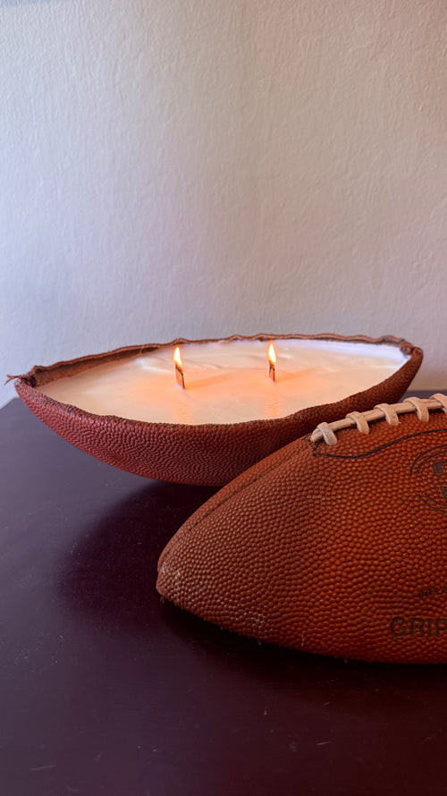 Vintage football candle lit with two wooden wicks
